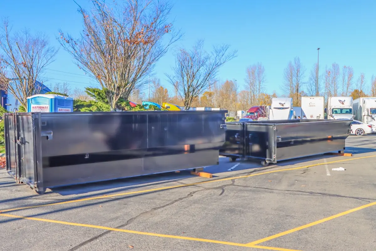 Professional dumpster rental service with roll-off container on residential driveway in Hilton